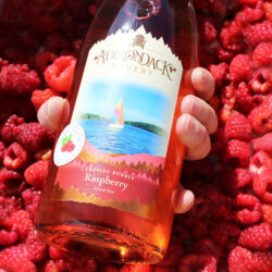 Lakeside-Bubbly-in-Raspberries-with-Hand-square-edited