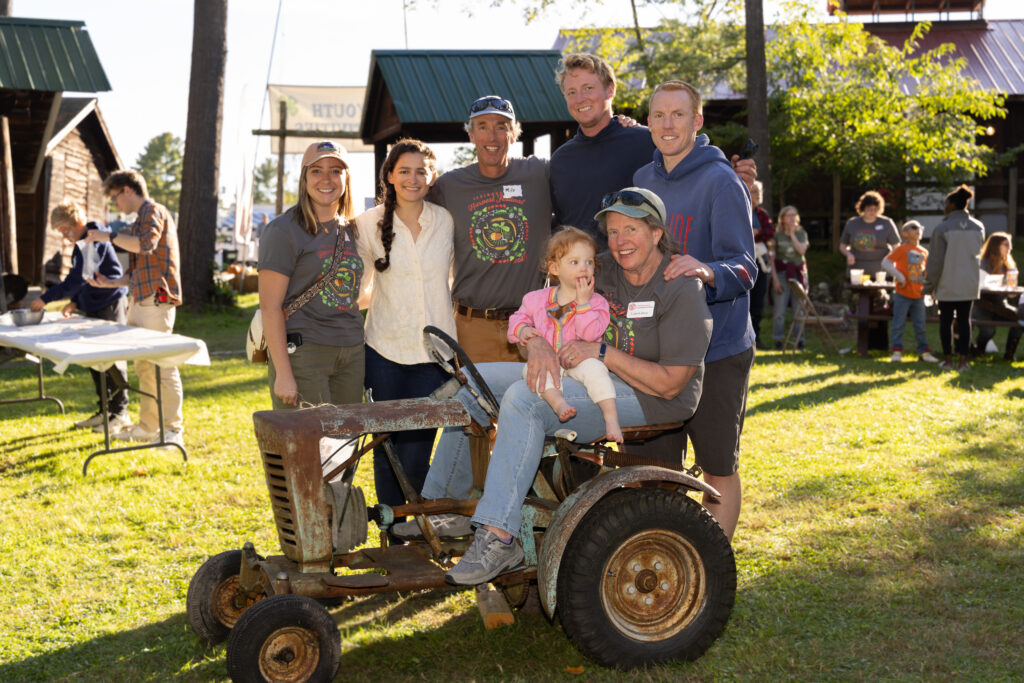 Laurie Davis, CCE Essex Senior Office Administrator, holds her granddaughter surrounded by family. Photo by Katie Kearney.