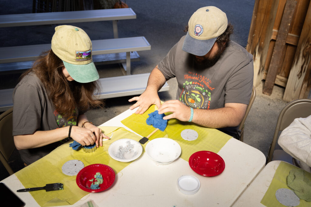 Rachael Trossman and Ryan Beattie making seed paper at the workshop during the 2025 festival. Photo by Katie Kearney.