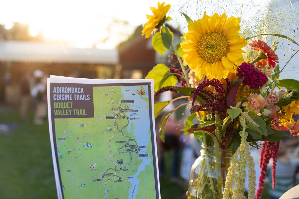 The Boquet Valley Cuisine Trail map with a bouquet of flowers. 