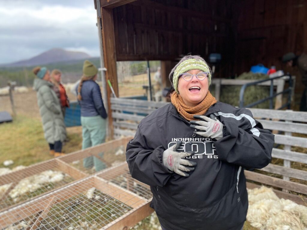Woman smiling outdoors with others in background