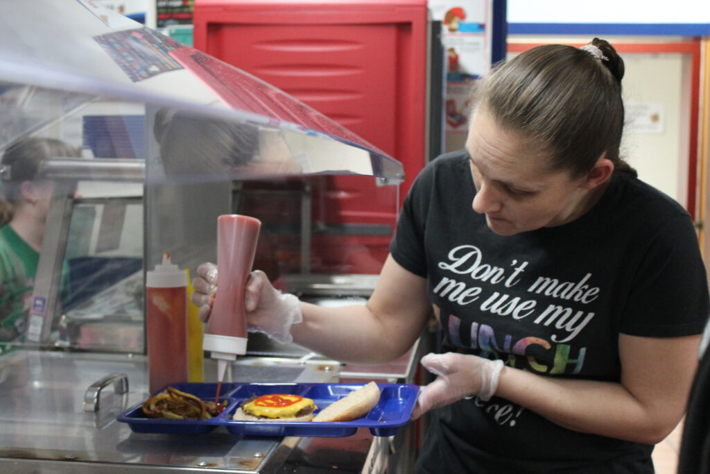 Woman preparing lunch with condiments