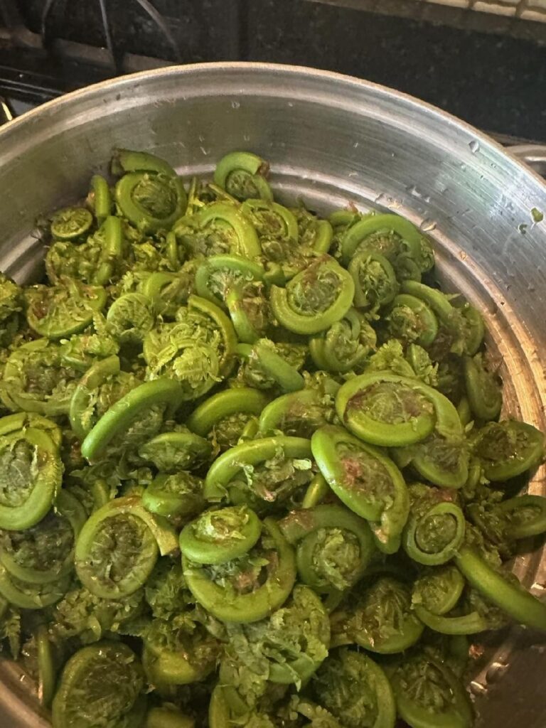 Sliced green vegetable in a large pot