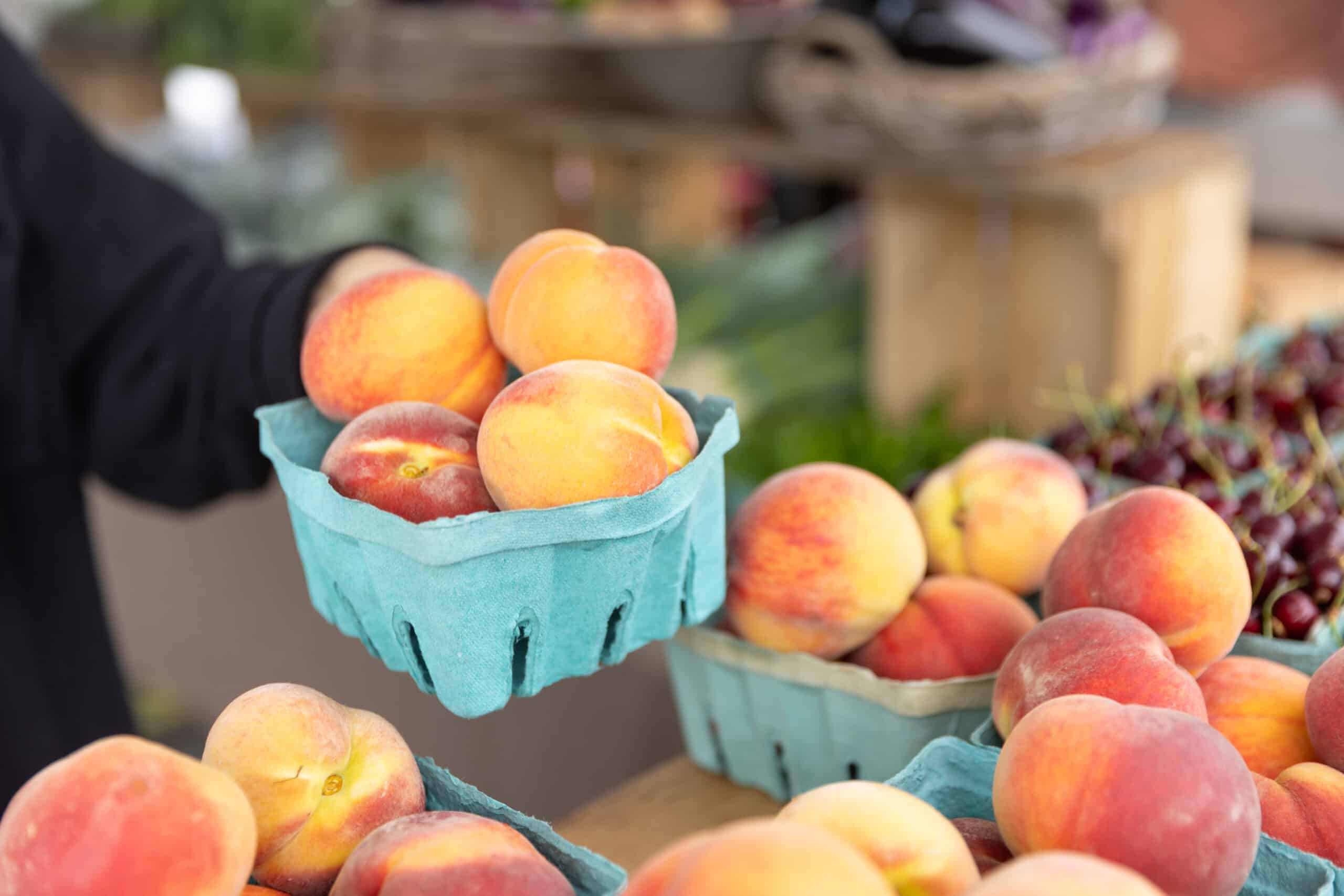 Basket of fresh peaches at market