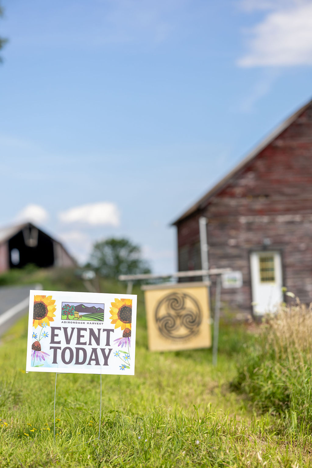 Event sign in a rural setting with barns