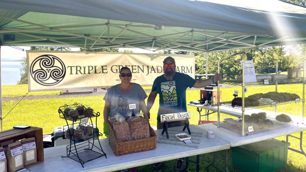 Farmers at outdoor market selling fresh pasta