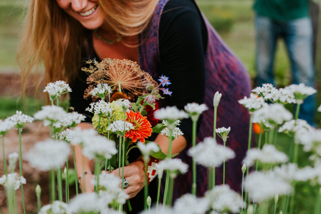 Woman picking flowers in a garden