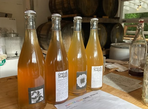 Four bottles of amber liquid on a table