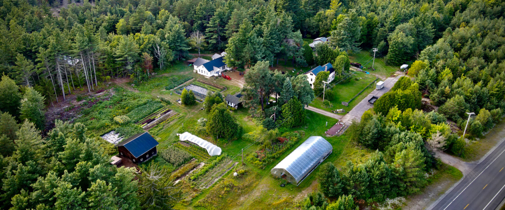 Aerial view of rural farm with greenhouses and gardens