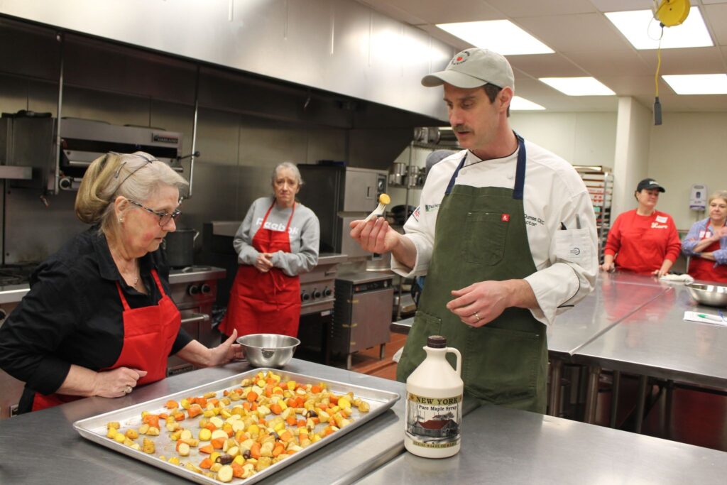 Cooking class with chef and participants in a kitchen
