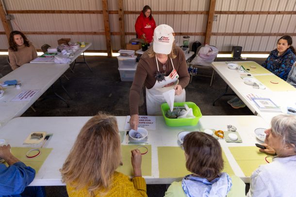 Workshop participants making crafts at tables.